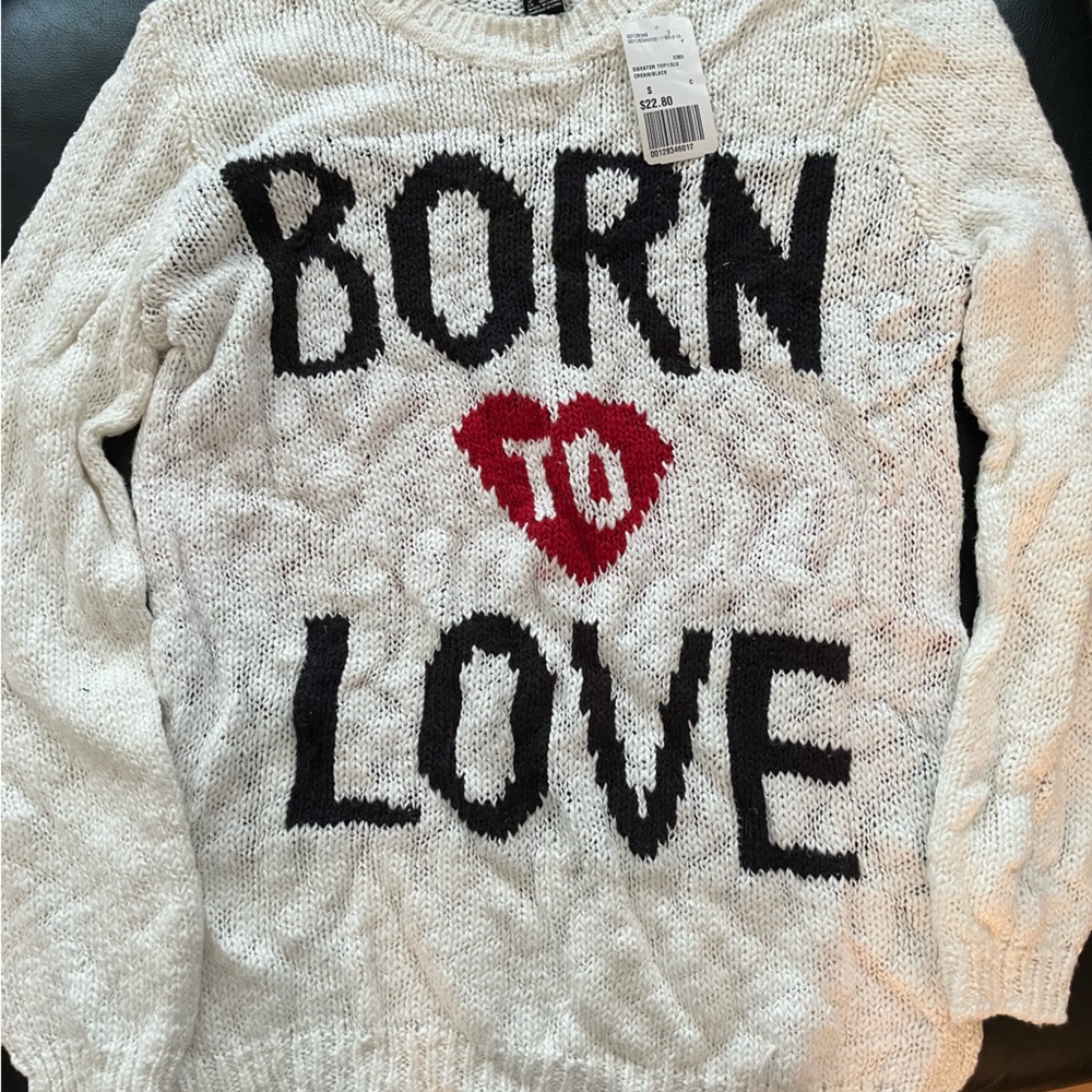 This is a White sweater with The Word Born To Love